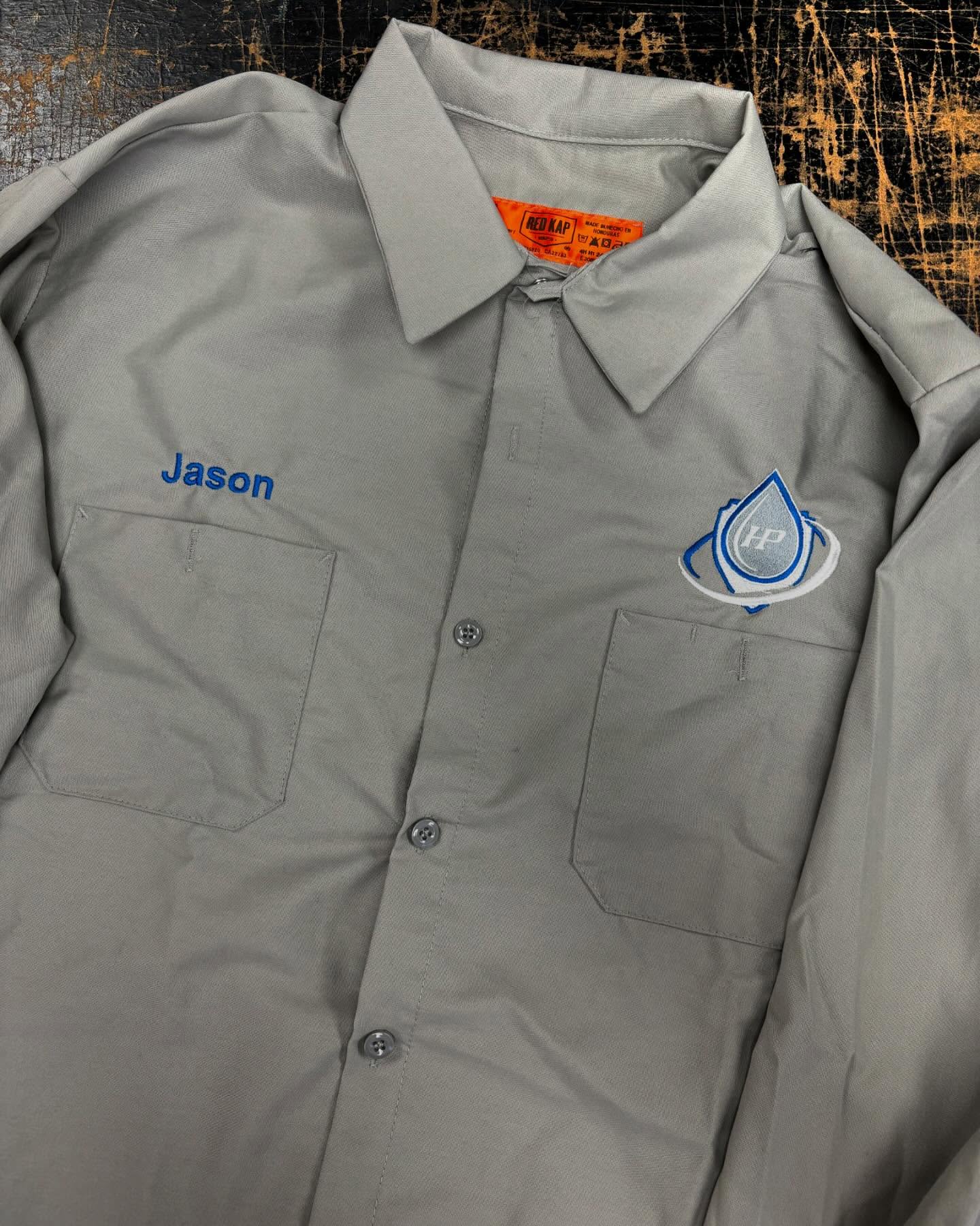 Gray button-up work shirt with an embroidered HP Team logo and a personalized name tag.