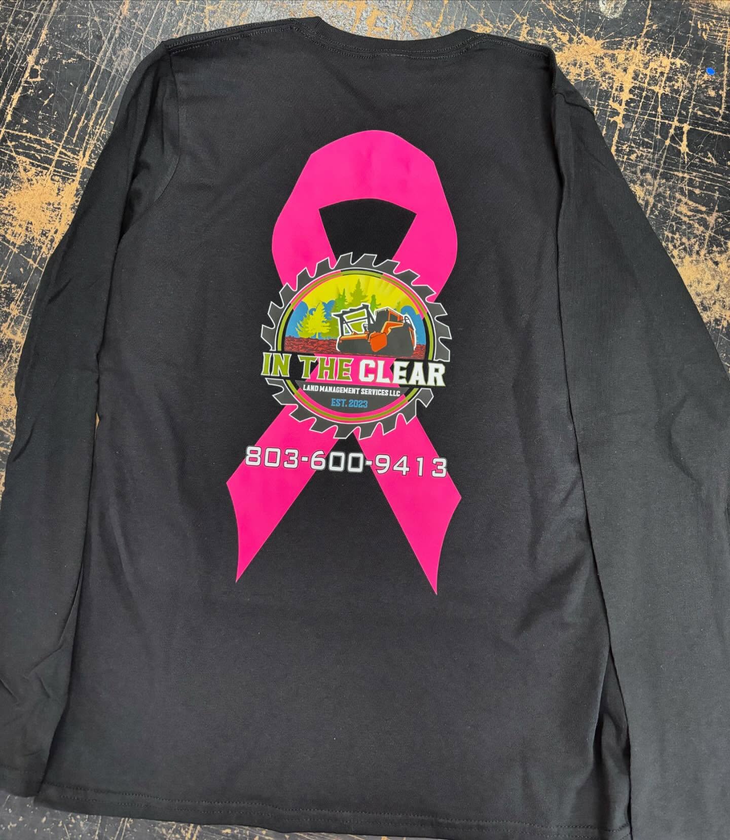 Black long-sleeve shirt featuring a bold land management logo with a pink ribbon.