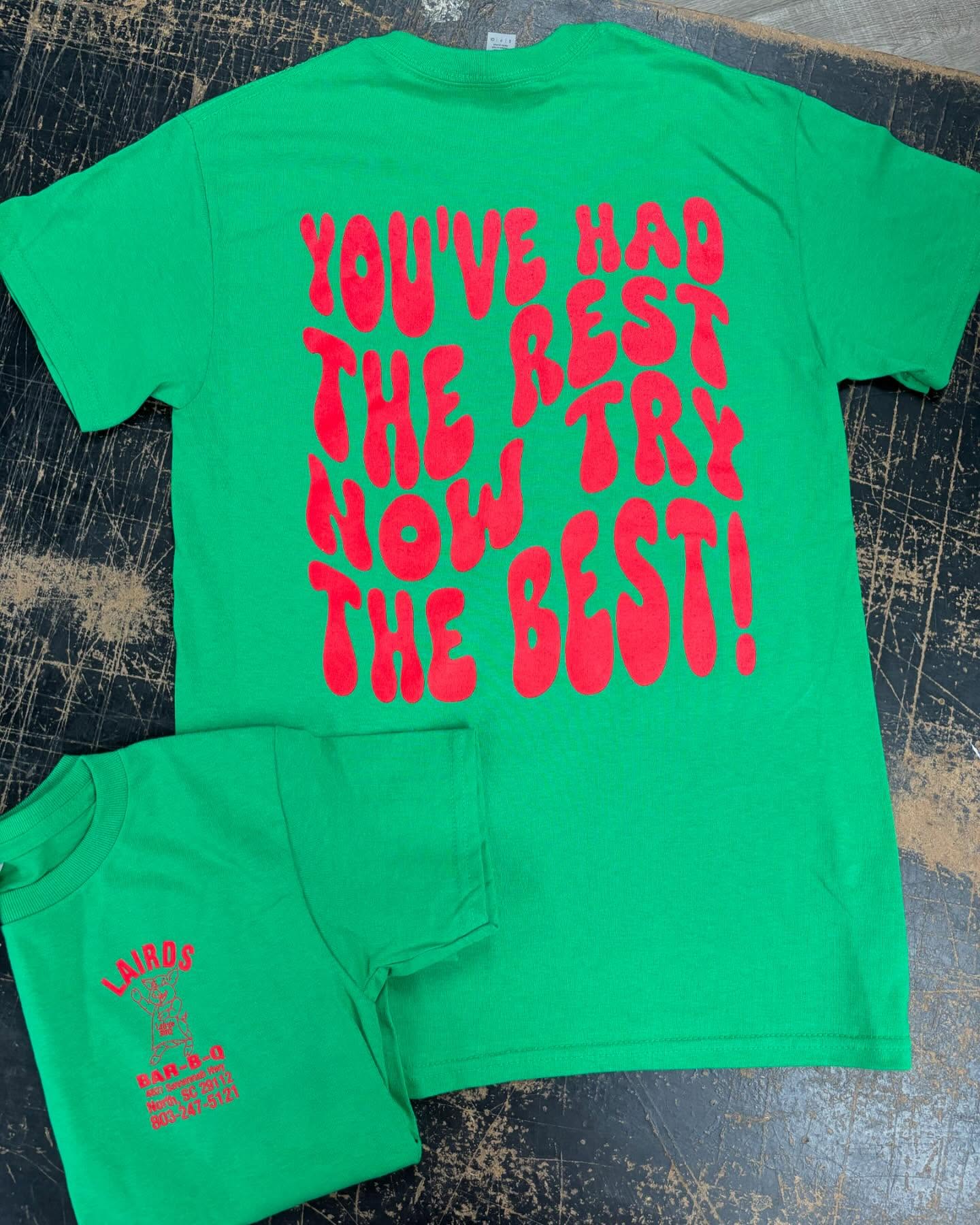 Bright green T-shirt with bold red text reading, "You've had the rest, now try the best!"