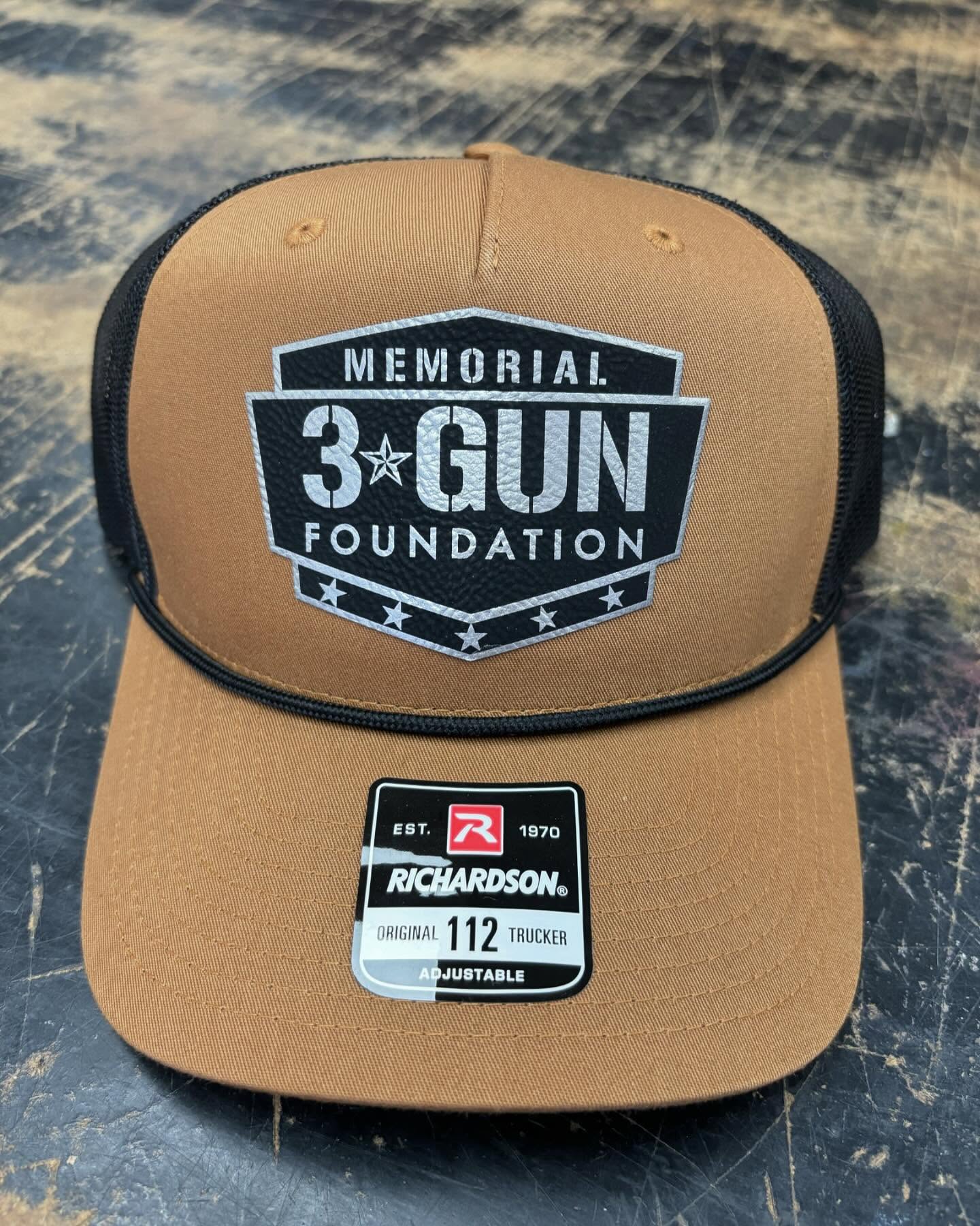 Brown Richardson 112 trucker hat with a black and white Memorial 3 Gun Foundation logo patch.