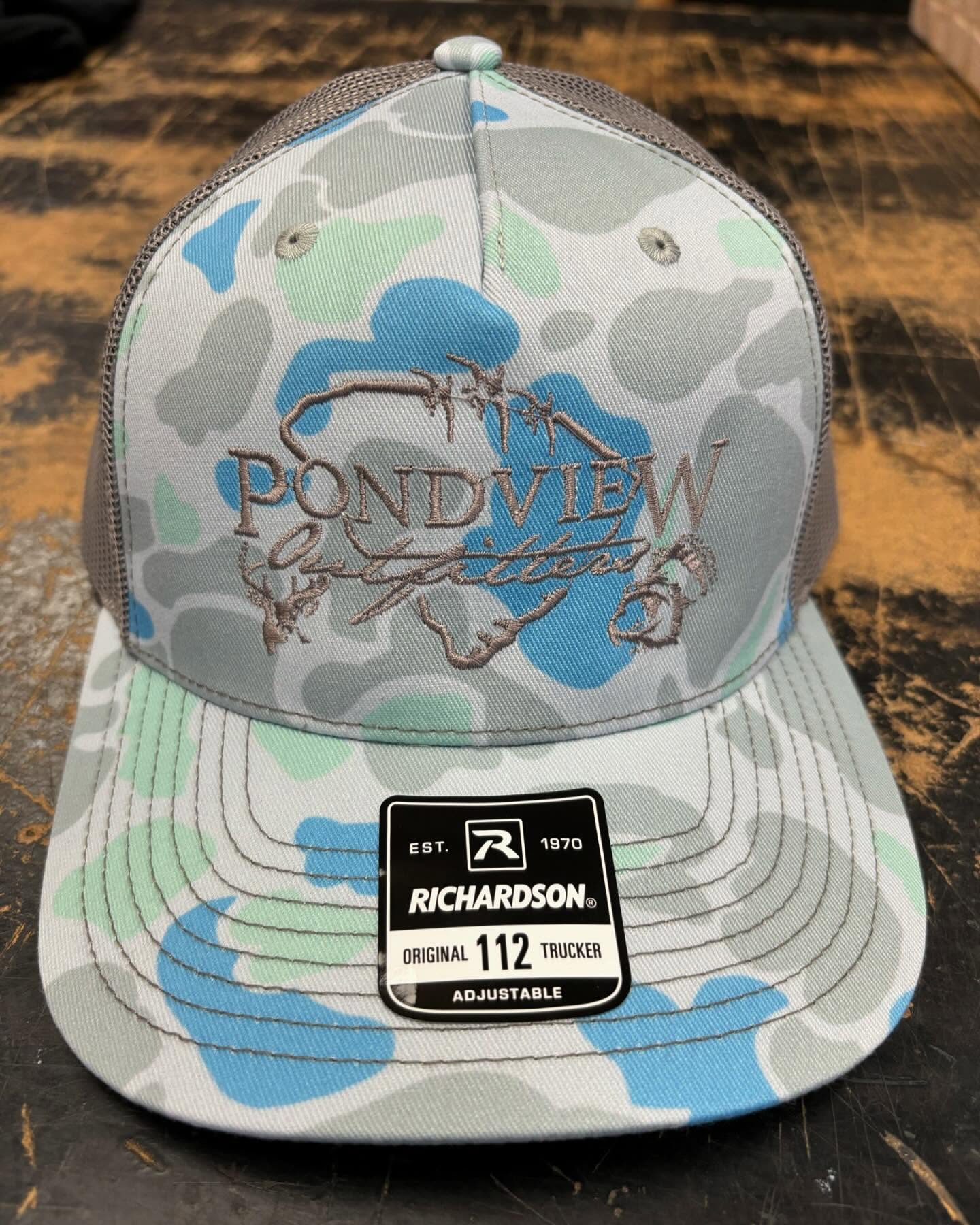 Gray and blue camouflage Richardson 112 trucker hat with embroidered Pondview logo.